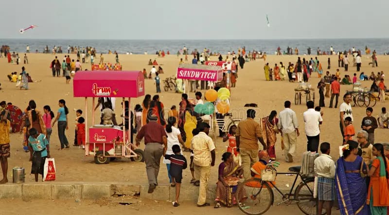 Visitors enjoying Marina Beach Chennai during a busy evening near food stalls and attractions