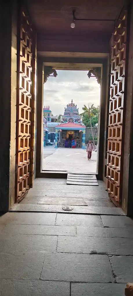 Temple entrance doorway framing a distant gopuram view Temple entrance doorway framing a distant gopuram view