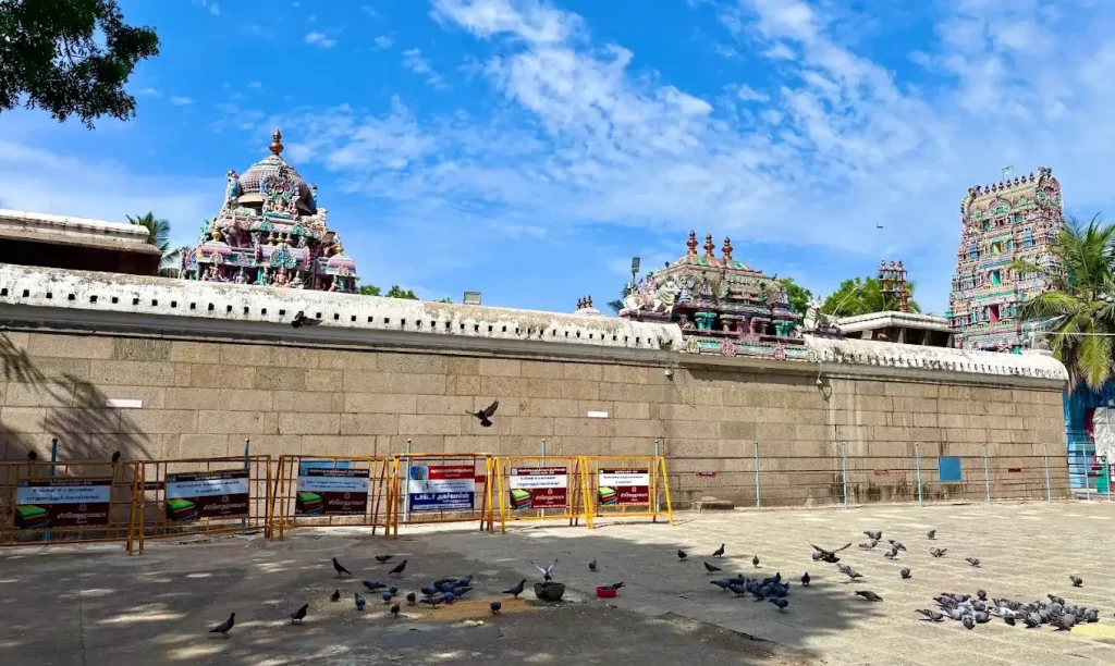 Wide view of Hindu temple complex with colorful gopuram and temple courtyard Wide view of Hindu temple complex with colorful gopuram and temple courtyard