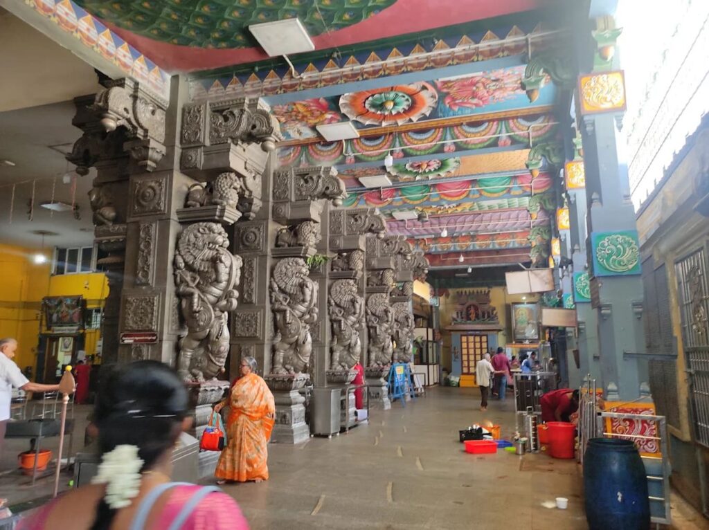 Interior hall of Kalikambal Temple with Yali carved stone pillars and painted ceiling