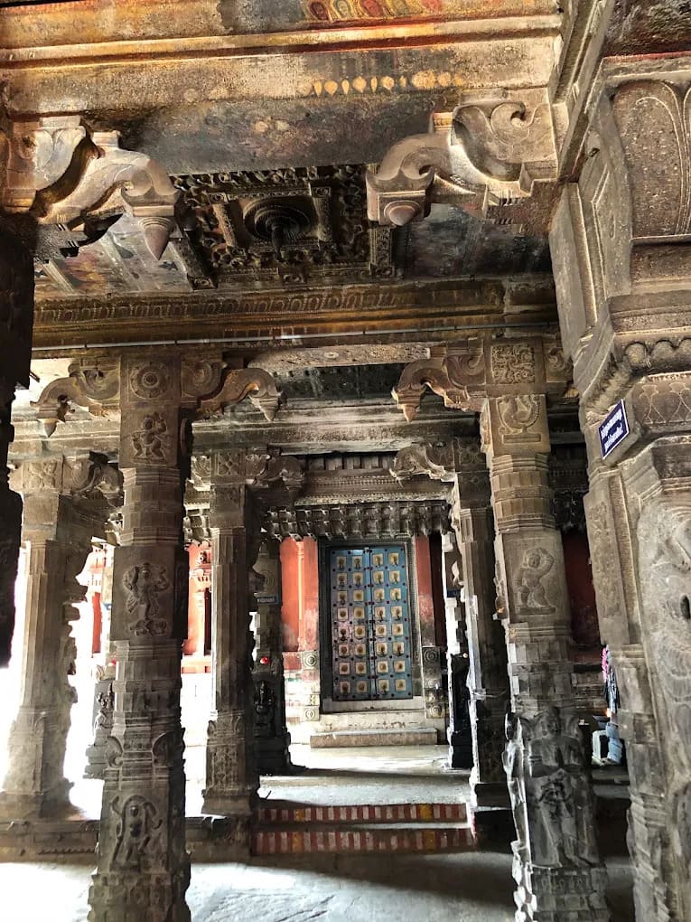 Carved granite pillars and stone Kodungai ceiling cornices inside Avudaiyarkoil temple mandapam Carved granite pillars and stone Kodungai ceiling cornices inside Avudaiyarkoil temple mandapam