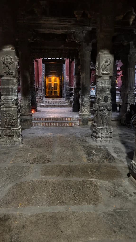 Illuminated sanctum door through carved stone pillar hall at Avudaiyarkoil Thiruperundurai temple Illuminated sanctum door through carved stone pillar hall at Avudaiyarkoil Thiruperundurai temple